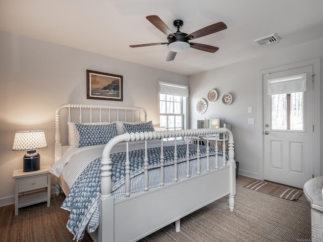 bedroom with baseboards, visible vents, and ceiling fan