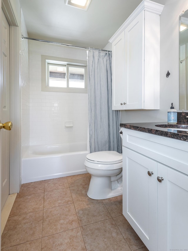 bathroom featuring tile patterned floors, toilet, vanity, and shower / bath combo