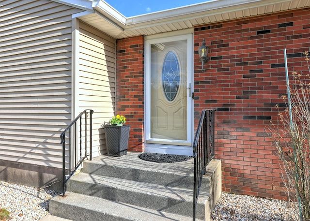 property entrance featuring brick siding