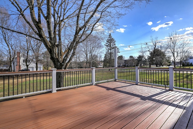 wooden terrace featuring a yard