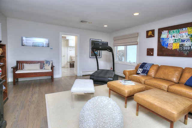 living area featuring visible vents, baseboards, recessed lighting, wood finished floors, and a baseboard heating unit