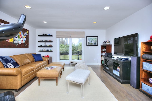 living area with recessed lighting and wood finished floors