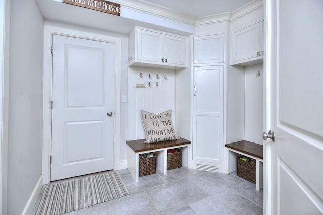 mudroom featuring light tile patterned floors and baseboards