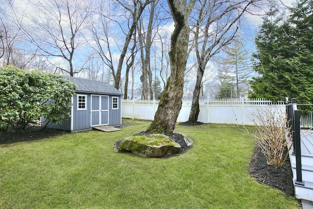 view of yard with a shed, fence private yard, and an outdoor structure