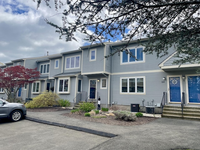 townhome / multi-family property featuring entry steps and central AC unit