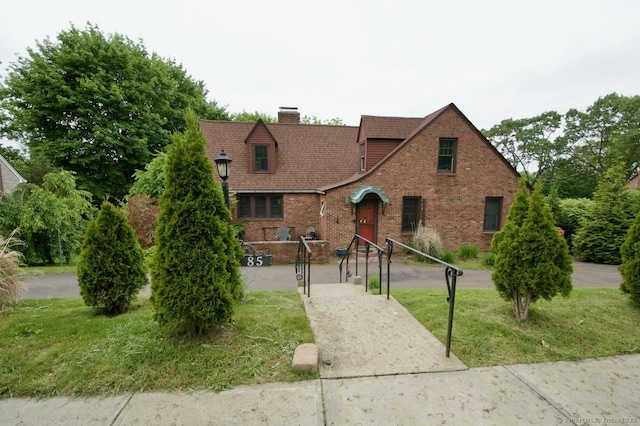 85 Hillcrest Ter, Meriden, CT 06450 - tudor house with brick siding, a chimney, and a front yard
