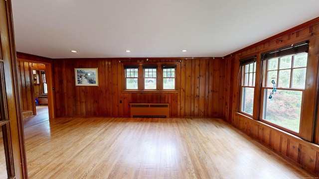 85 Hillcrest Ter, Meriden, CT 06450 - spare room with radiator, light wood-style flooring, wood walls, and recessed lighting