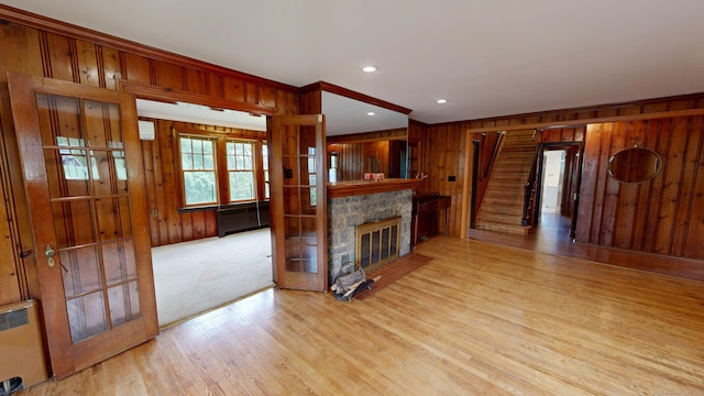 85 Hillcrest Ter, Meriden, CT 06450 - unfurnished living room featuring wood walls, wood finished floors, a fireplace, crown molding, and stairway