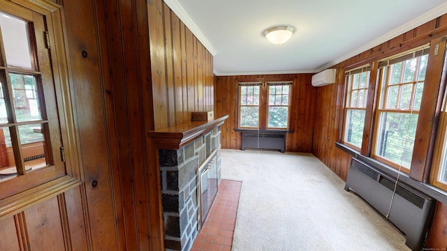 85 Hillcrest Ter, Meriden, CT 06450 - unfurnished living room featuring a wall mounted air conditioner, radiator heating unit, wood walls, a fireplace with flush hearth, and light colored carpet