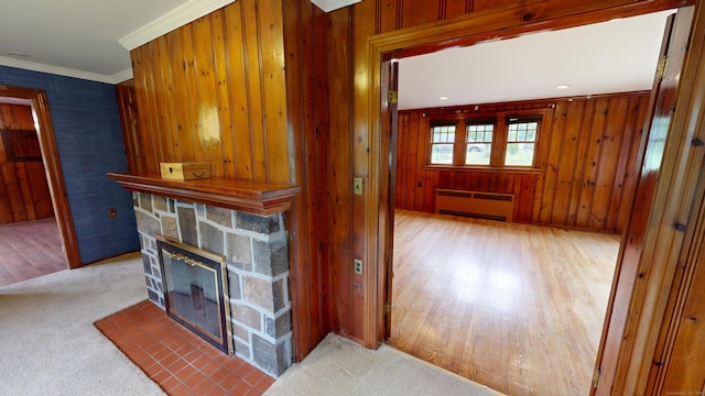 85 Hillcrest Ter, Meriden, CT 06450 - living room featuring radiator heating unit, a stone fireplace, ornamental molding, wood finished floors, and wooden walls