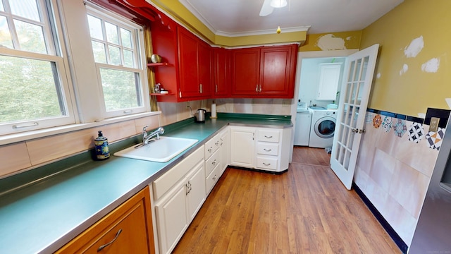 85 Hillcrest Ter, Meriden, CT 06450 - kitchen with a sink, independent washer and dryer, light wood-style floors, white cabinets, and wainscoting