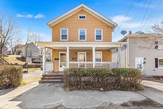 traditional style home featuring covered porch
