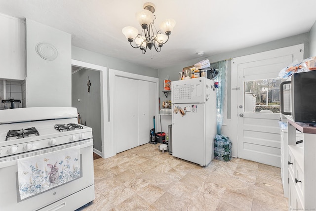 kitchen with white appliances and a chandelier