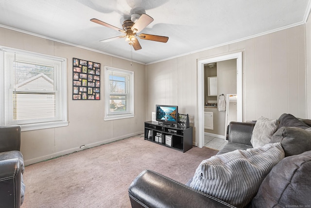 living area with ceiling fan, ornamental molding, and carpet floors