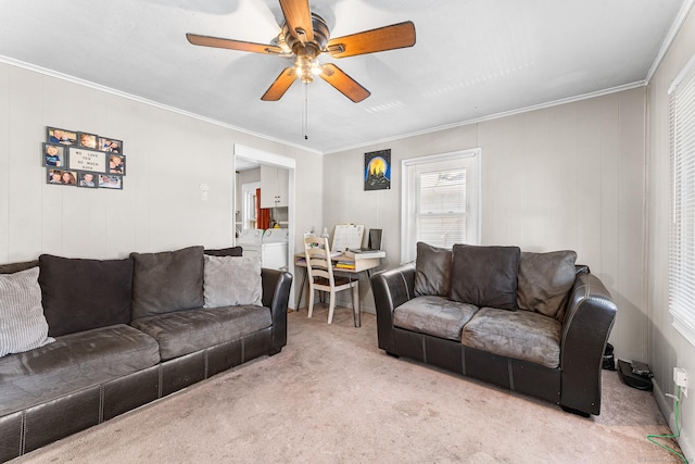 carpeted living area featuring crown molding and a ceiling fan
