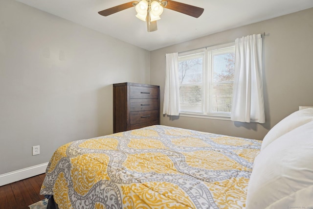 bedroom with hardwood / wood-style flooring, baseboards, and a ceiling fan