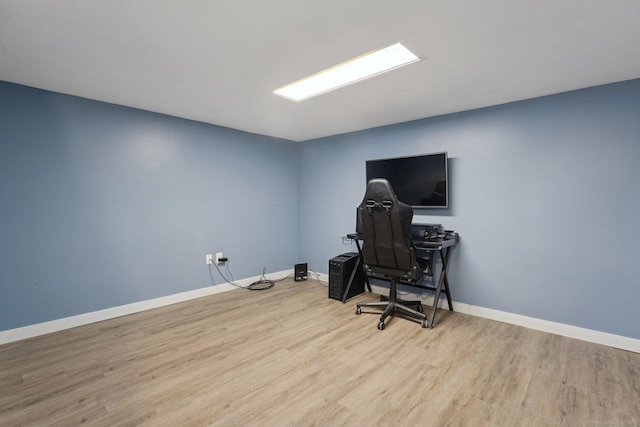 living area featuring wood finished floors and baseboards