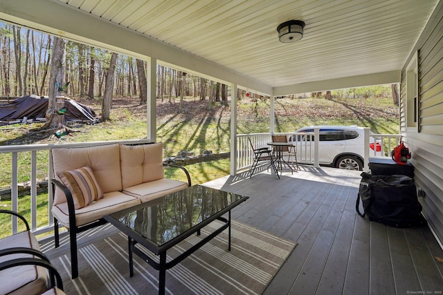 wooden terrace with an outdoor living space and outdoor dining area