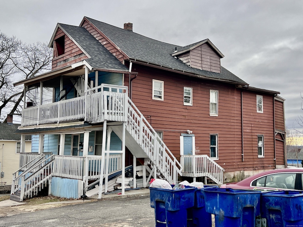 199 Hill St, Waterbury, CT 06704 - rear view of property with stairs, a porch, a chimney, and a shingled roof