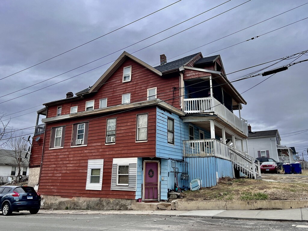199 Hill St, Waterbury, CT 06704 - view of front facade featuring a chimney and a balcony