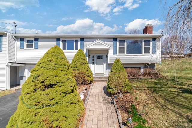 bi-level home featuring a chimney