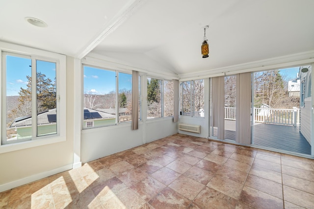 unfurnished sunroom featuring lofted ceiling and a wall mounted air conditioner