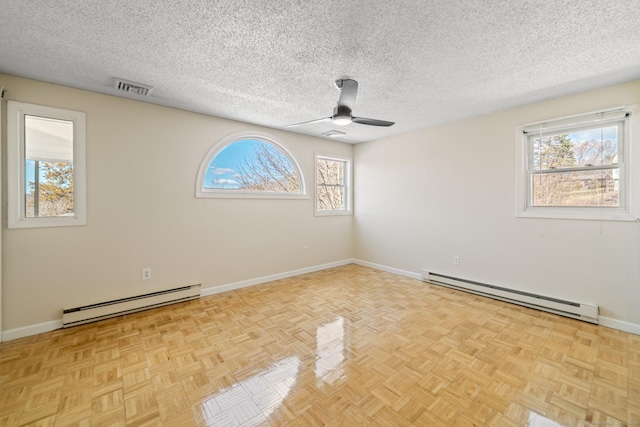 empty room with baseboards, visible vents, a baseboard radiator, a textured ceiling, and baseboard heating