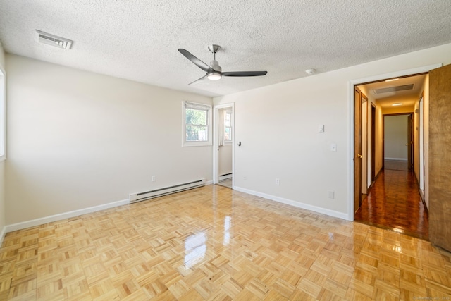 empty room with visible vents, baseboards, ceiling fan, and a baseboard radiator