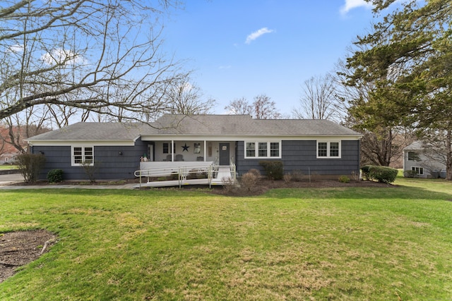 view of front of property with a sunroom and a front lawn