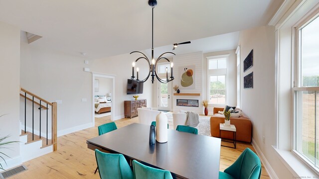 81 Shea Cir, Cheshire, CT 06410 - dining space with light wood-style flooring, visible vents, a chandelier, baseboards, and stairway