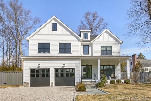 modern inspired farmhouse featuring fence, board and batten siding, and a porch