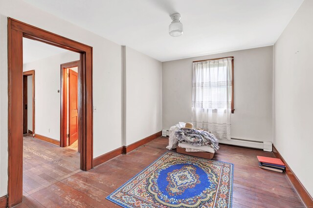 interior space featuring baseboards, baseboard heating, and hardwood / wood-style floors