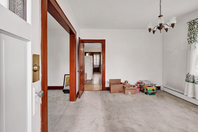 recreation room featuring carpet floors, a baseboard heating unit, and a notable chandelier
