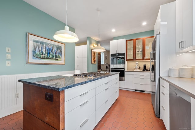 277 Milton Rd, Warren, CT 06756 - kitchen with appliances with stainless steel finishes, a kitchen island, a wainscoted wall, white cabinets, and recessed lighting