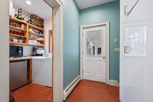 277 Milton Rd, Warren, CT 06756 - laundry room featuring a baseboard heating unit, washing machine and dryer, dark tile patterned flooring, and baseboards