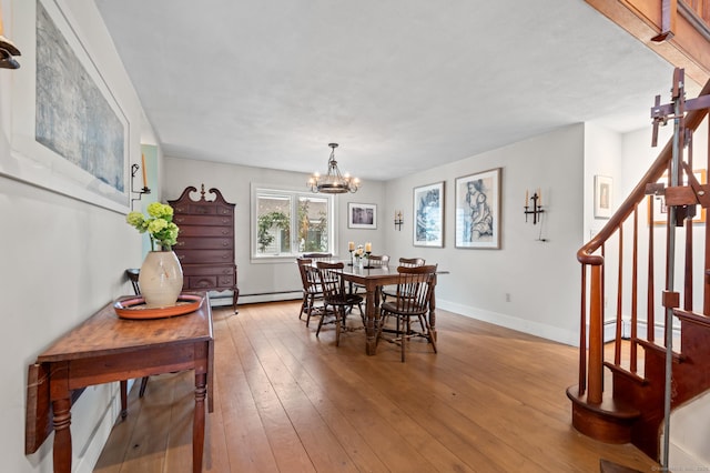 277 Milton Rd, Warren, CT 06756 - dining area with stairs, baseboard heating, a chandelier, hardwood / wood-style flooring, and baseboards