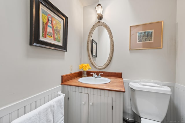 277 Milton Rd, Warren, CT 06756 - bathroom featuring a wainscoted wall, vanity, and toilet