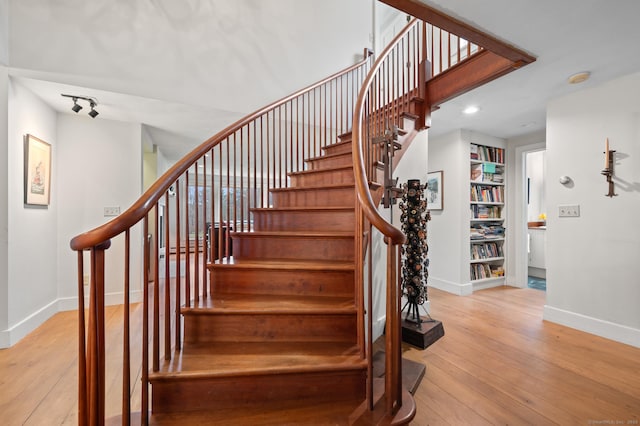 277 Milton Rd, Warren, CT 06756 - stairs featuring baseboards, wood-type flooring, built in features, and recessed lighting