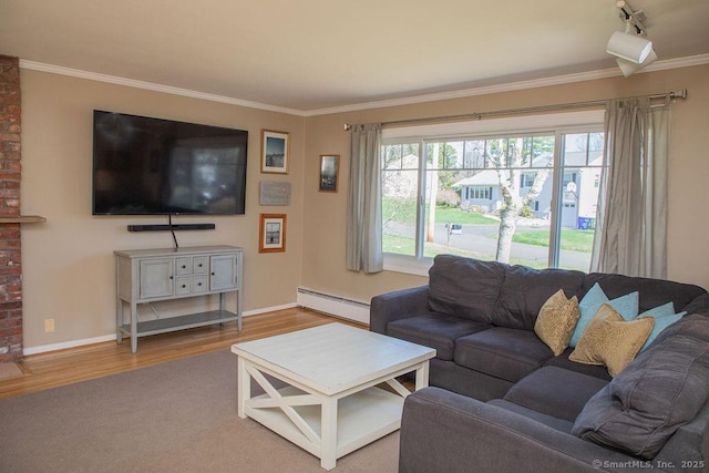 living area with crown molding, baseboards, baseboard heating, and wood finished floors