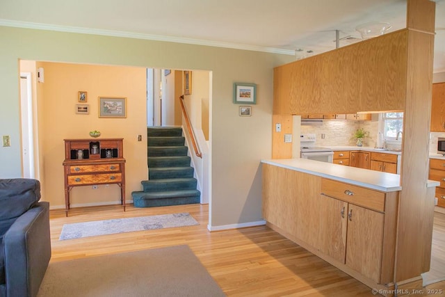 kitchen featuring ornamental molding, white appliances, light wood-style floors, baseboards, and backsplash