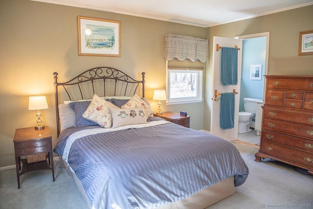 bedroom featuring crown molding, carpet floors, and ensuite bathroom