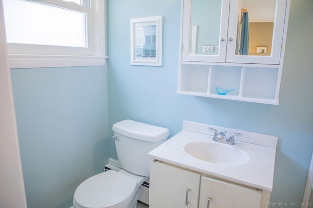 bathroom with vanity, a baseboard heating unit, and toilet