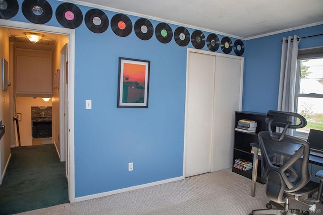 carpeted office space featuring crown molding and baseboards