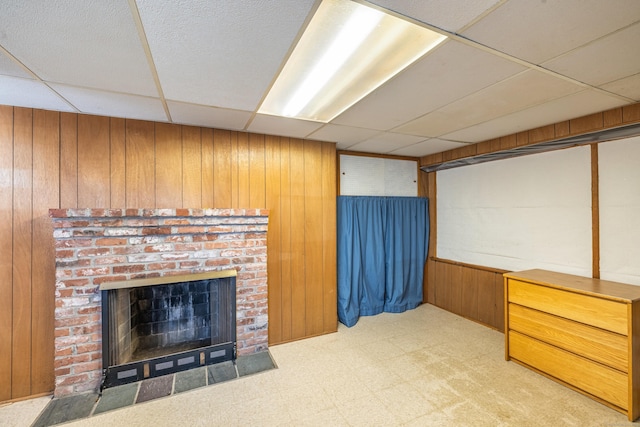 127 Separatist Rd, Mansfield, CT 06268 - unfurnished living room with a paneled ceiling, wood walls, tile patterned floors, and a fireplace
