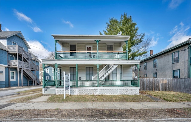 view of front of property featuring covered porch and fence