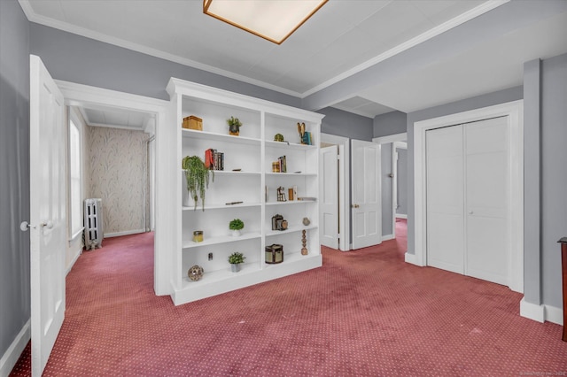 carpeted bedroom featuring a closet, baseboards, radiator, and crown molding
