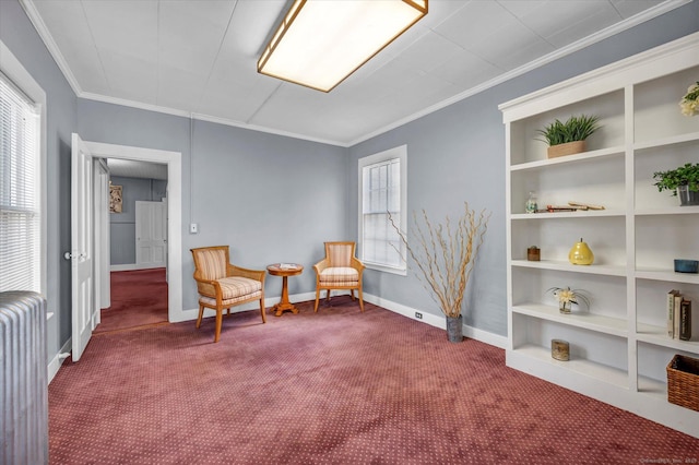 sitting room with ornamental molding, radiator, carpet, and built in shelves