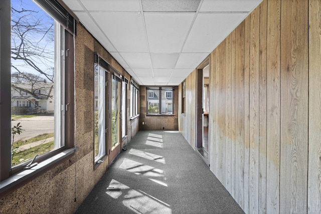 1228 Wells Pl, Stratford, CT 06615 - unfurnished sunroom with wood walls, a drop ceiling, and carpet flooring