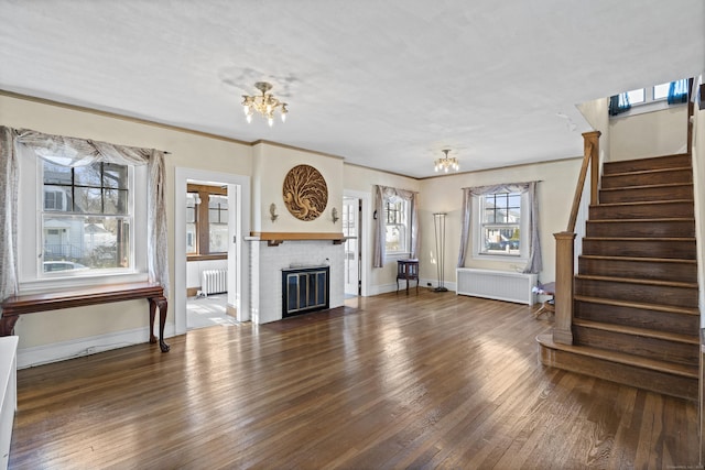 1228 Wells Pl, Stratford, CT 06615 - unfurnished living room with radiator, a chandelier, and wood finished floors