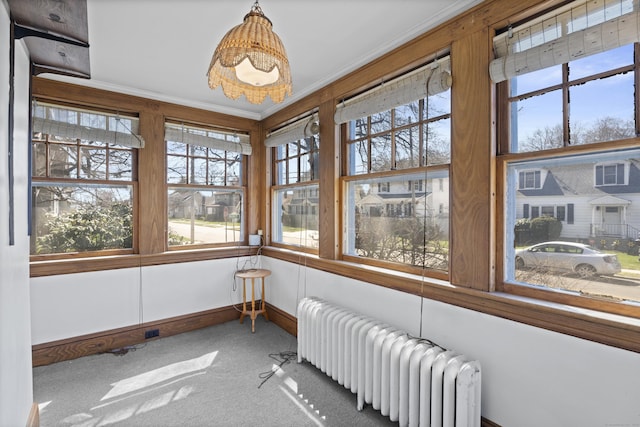 1228 Wells Pl, Stratford, CT 06615 - sunroom with radiator heating unit, crown molding, carpet, plenty of natural light, and baseboards